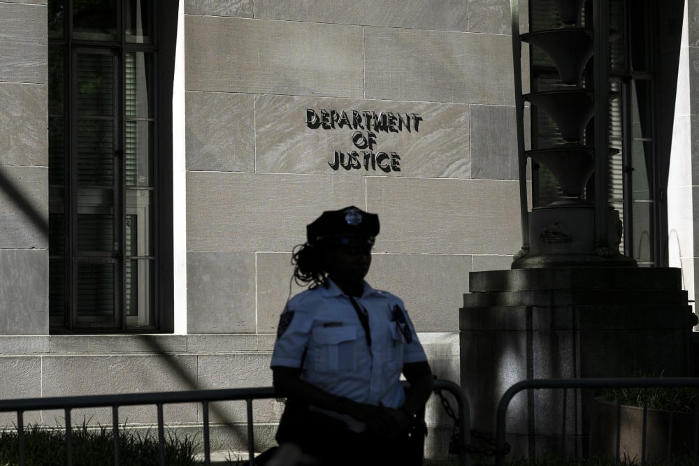 A police officer stands guard outside the US Department of Justice building in Washington, D.C.