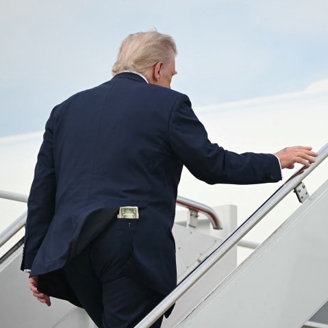 A fifty-dollar bill is seen in President Donald Trump's back pocket as he boards Air Force One.
