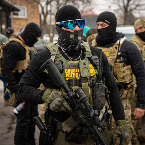 Federal agents stand together.