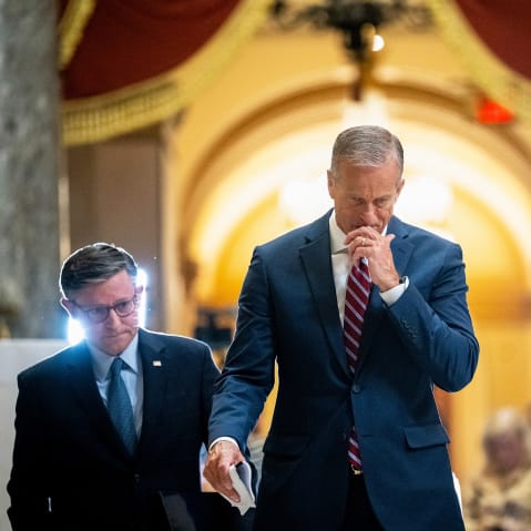 Mike Johnson, left, and John Thune leave. Press can be seen in the background.