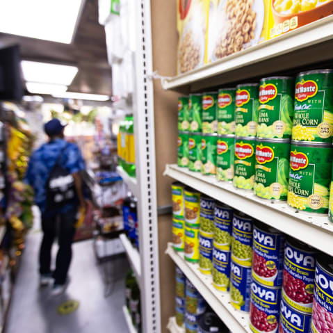 Canned food and other products in an aisle at a grocery store in NY
