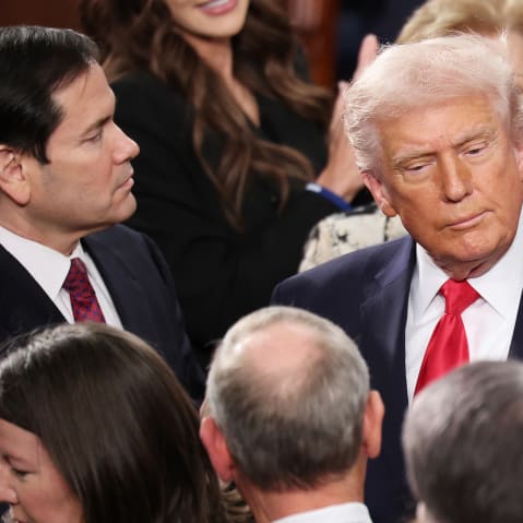 Marco Rubio, left, looks ahead while Donald Trump is facing the camera.