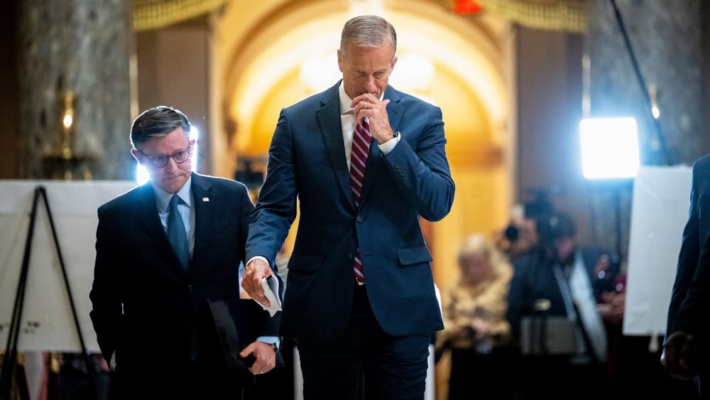 Mike Johnson, left, and John Thune leave. Press can be seen in the background.