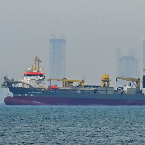 A commercial ship is anchored off the coast of the United Arab Emirates, in the Strait of Hormuz.