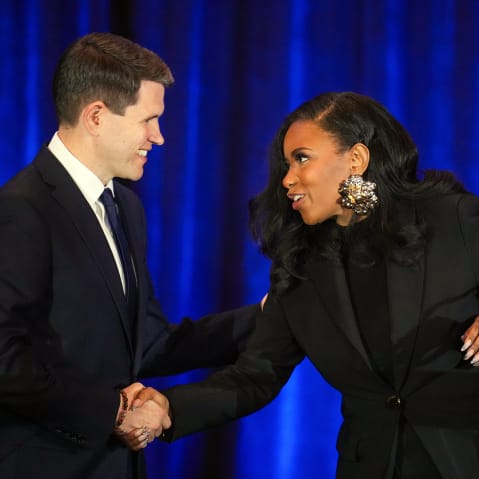 State Representative James Talarico and Representative Jasmine Crockett shake hands during a debate.