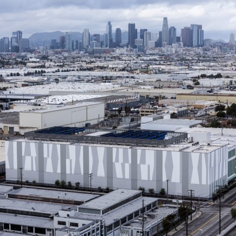 A data center is photographed from above with city skyline in the background.