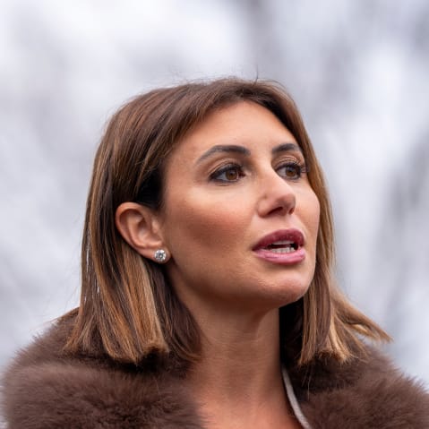 A neck-up photo of Alina Habba outside.