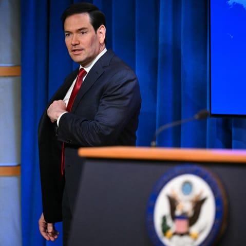 Marco Rubio arrives to speak during an end-of-year press conference.