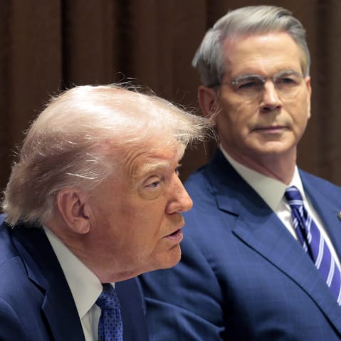 Treasury Secretary Scott Bessent listens as President Donald Trump delivers remarks.