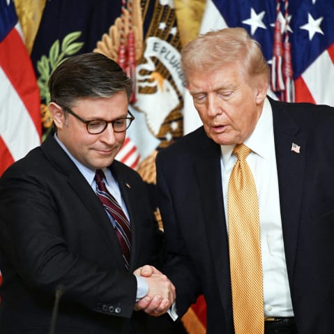 President Donald Trump shakes hands with Speaker of the House Mike Johnson during a lunch with the Kennedy Center Board Members.