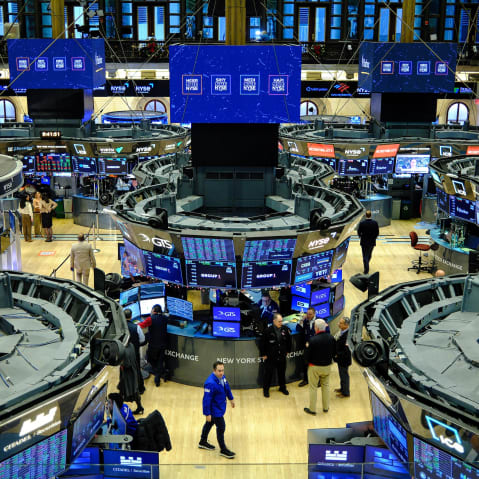 Traders work on the floor of the New York Stock Exchange at the opening bell in New York.