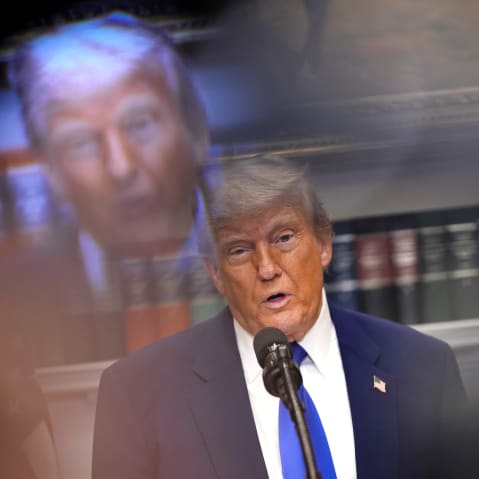 Donald Trump and his reflection through a camera is seen in this tilted frame.