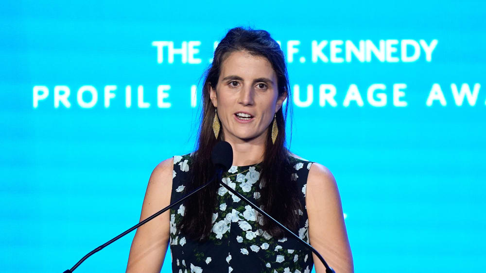 Tatiana Schlossberg speaks at a podium.
