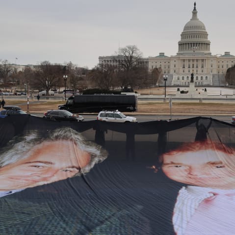 A photo of President Donald Trump and convicted sex offender Jeffrey Epstein is unfurled on the National Mall near the U.S. Capitol.