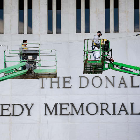 Workers adjust the name of the “John F. Kennedy Memorial Center for the Performing Arts" on Dec. 19, 2025, in Washington, D.C.