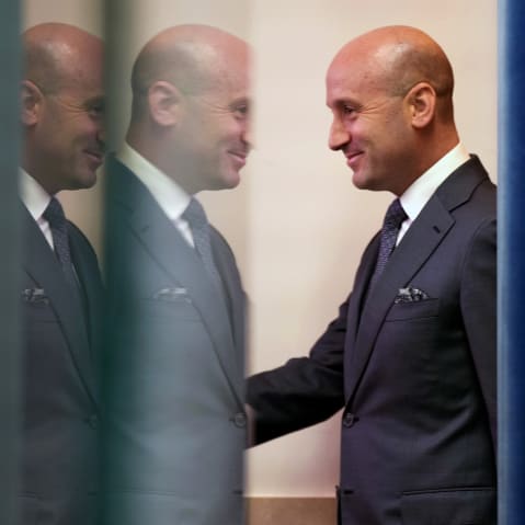 Stephen Miller walks into the press briefing room in the White House.