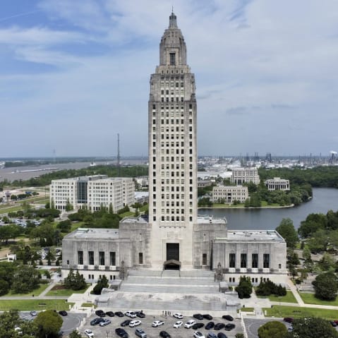 LA state capitol building photographed from above. The whole building and its surroundings are visible.