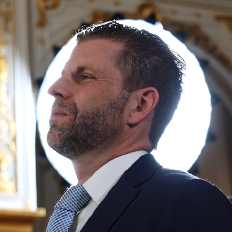 Eric Trump's profile is seen in front of a round white light source.