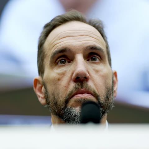 A closeup of Jack Jmith's face is photographed from below.