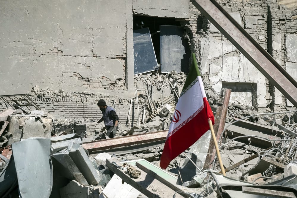 An unidentified man among the ruins of a police station that is struck during U.S.-Israeli attacks in Tehran.