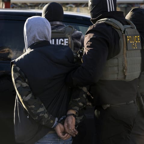 A Federal Agent arrest a man after stopping and questioning him in the street during an Immigration Enforcement Operation on Jan. 14, 2026 in Minneapolis.
