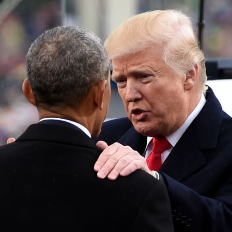 Donald Trump, right, speaks and rests his hand on Barack Obama's shoulder.