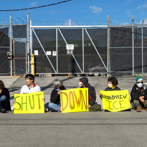 Protesters and activists sit in front of a gate to the Immigration and Customs Enforcement facility on Sept. 5, 2025 in Broadview, IL.