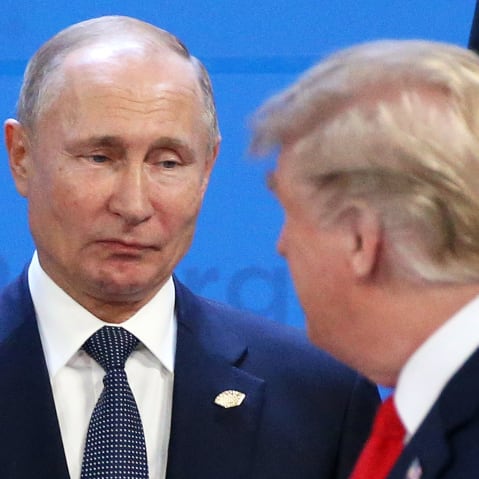 Russian President Vladimir Putin looks at President Donald Trump.