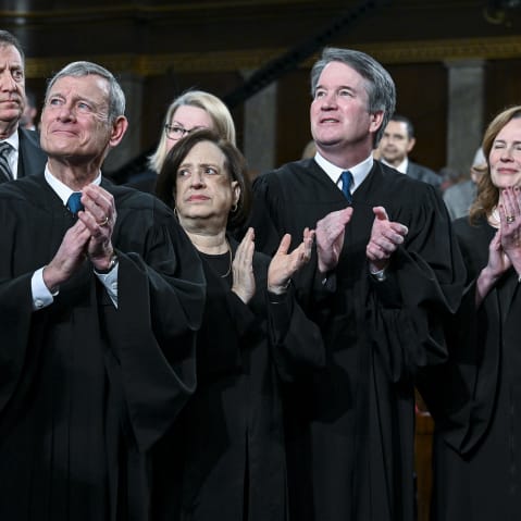 SCOTUS justices applaud as they stand.