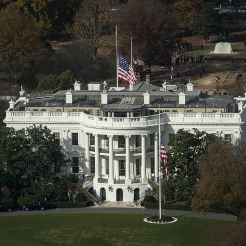 A photo of the white house front face shot from above.