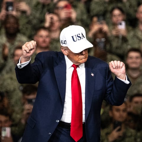 President Donald Trump dances in front of troops.