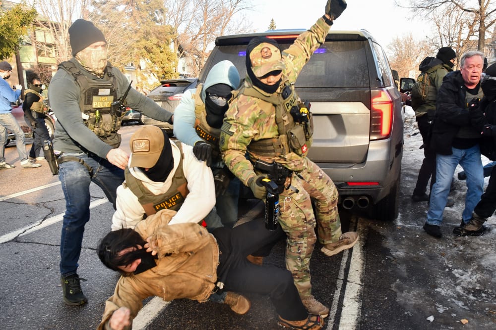 ICE and other federal officers detain a person during protests on Jan. 13, 2026 in Minneapolis.