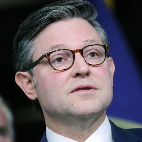 Mike Johnson speaking to the journalists in a very closeup frame. Photo is shot from below.