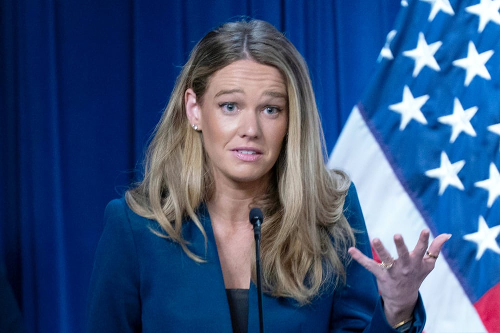 Tricia McLaughlin gestures with her hand as he speaks during a presser.