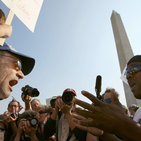 Two men shout at each other in this photo shot from below.