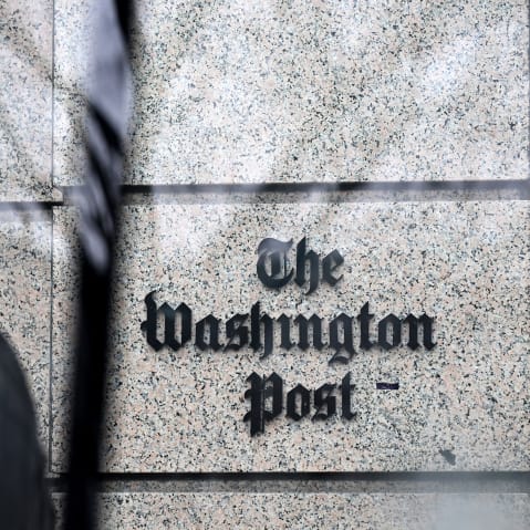 The Post sign is visioble through a glass