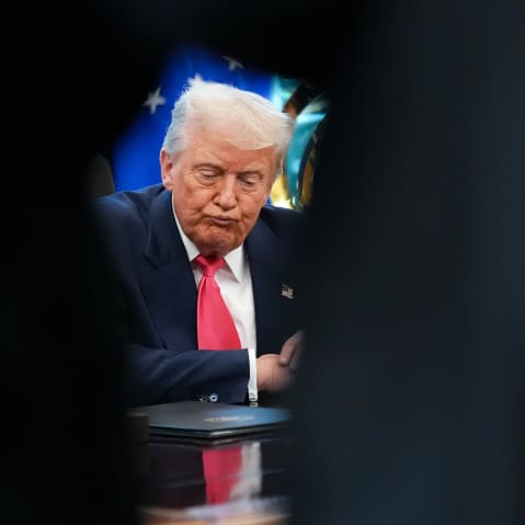 U.S. President Donald Trump answers questions from reporters in the Oval Office.