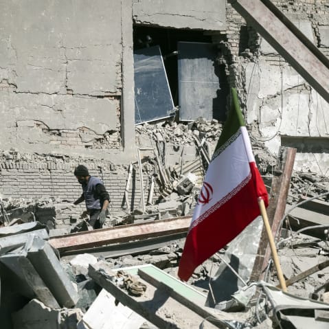 An unidentified man among the ruins of a police station that is struck during U.S.-Israeli attacks in Tehran.