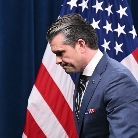 Pete Hegseth walks out to the left of the frame.