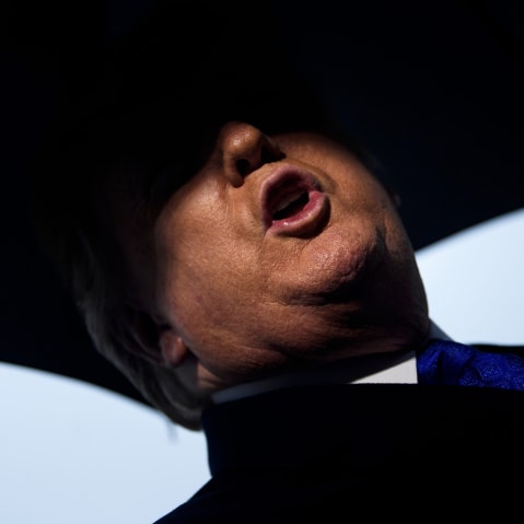 President Donald Trump speaks to the press before departing from the White House.