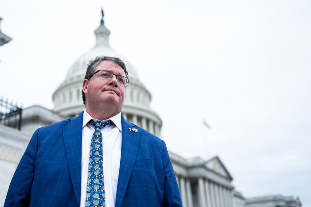 Randy Fine looks on as he is photographed from below in front of the capitol building.