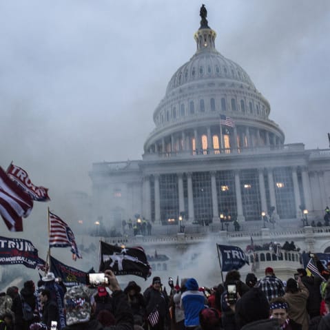 Security forces respond with tear gas after the President Donald Trump's supporters breached the US Capitol security.