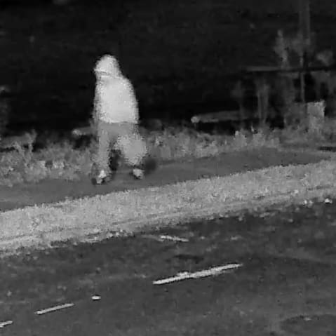 Seen in a surveillance footage, the pipe bomber case suspect is walking in the Capitol Hill neighborhood, wearing a hoodie.
