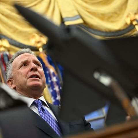 Steve Witkoff speaks in the Oval Office, seen in focus behind a statue of a jet in the foreground.