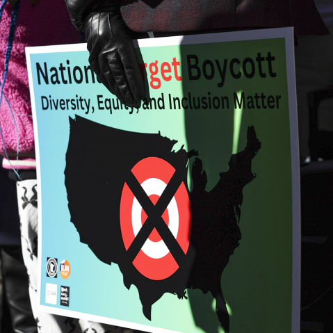 A community member holds a sign calling for a national boycott of Target stores.