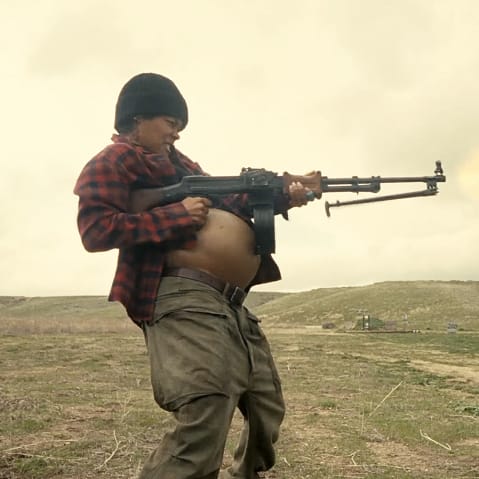 Teyana Taylor as Perfidia Beverly Hills firing a weapon while pregnant in the 2025 film "One Battle After Another."