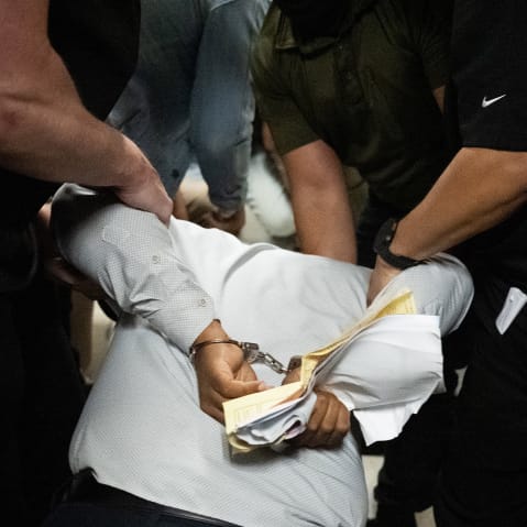 Ice agents detain a person as he exits an immigration courtroom hearing at the Jacob K. Javitz Federal Building.