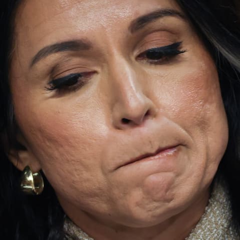 A close up of Tulsi Gabbard as she bites her lip.