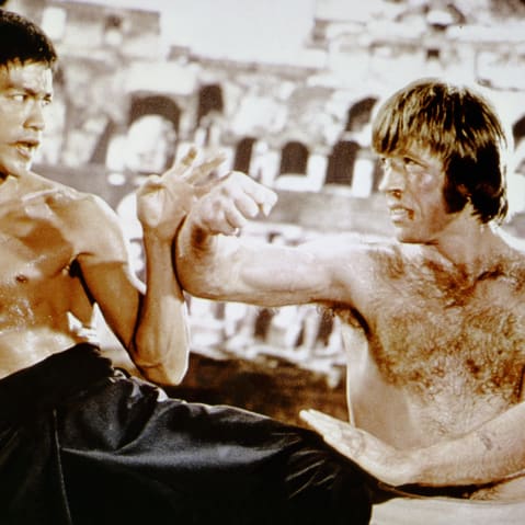 Bruce Lee, left, and Chuck Norris practice martial arts.