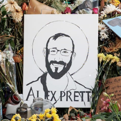 Signs and flowers left by mourners at the makeshift memorial for Alex Pretti on Jan. 29, 2026, in Minneapolis.